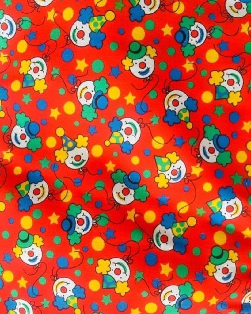 Vibrant Kidcore wallpaper with smiling balloon clowns colorful hats yellow stars red background
