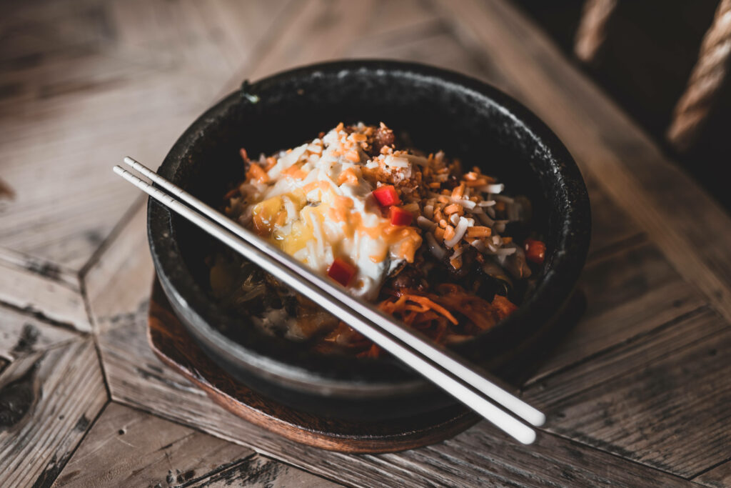Colorful Kimchi Rice Bowl with Sauce: Inviting Rustic Wallpaper