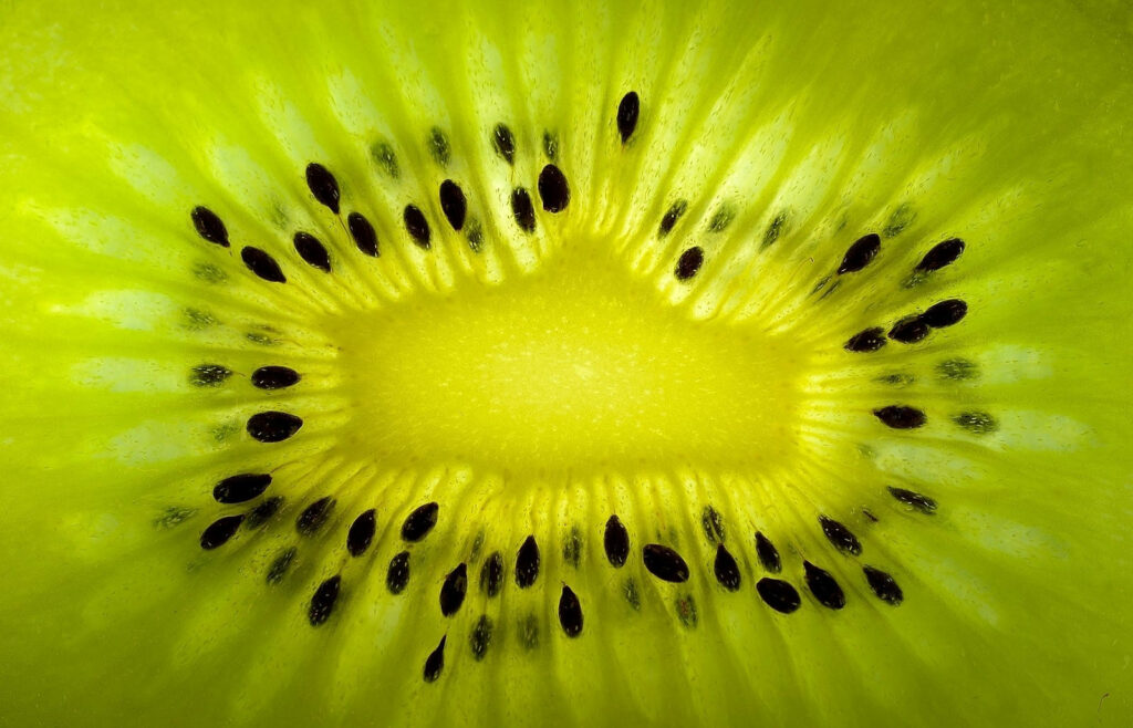 Vibrant Kiwi Macro Shot: Bright Green Core & Textured Wallpaper