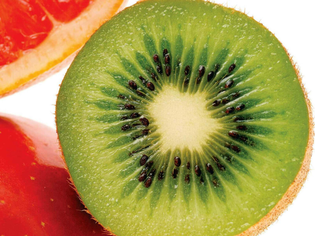 Juicy Kiwi Slice Wallpaper: Vibrant Green Background for Any Screen