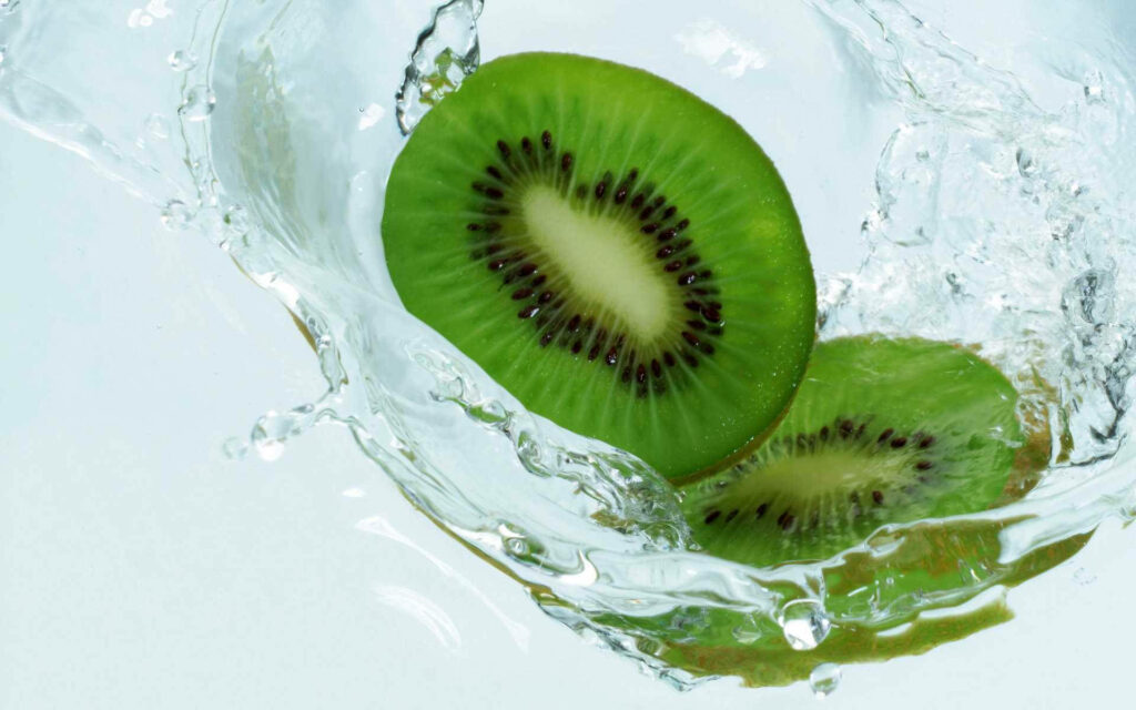 Vibrant Kiwi Splash Wallpaper: Refreshing Background Delight