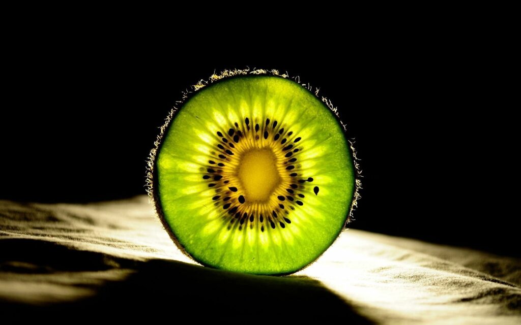 Vibrant Kiwi Wallpaper: Bright Green Center & Seed Pattern Design