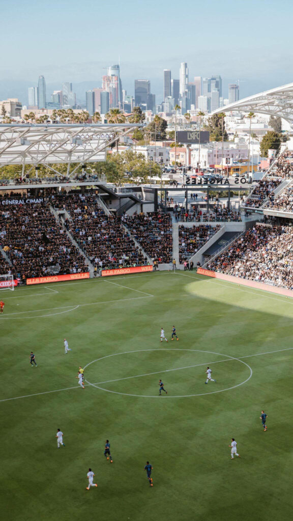 LAFC Stadium Phone Wallpaper: Intense Match with LA Skyline View