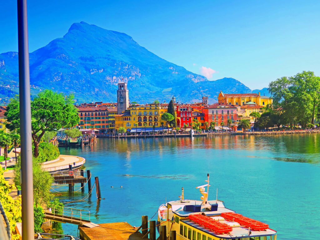 Colorful Waterfront at Lago di Garda: Vibrant Wallpaper Background