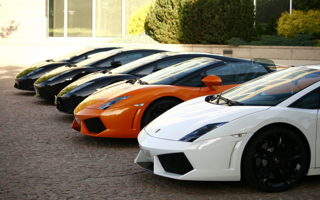 Vibrant Lamborghini Gallardos: Orange Star Amidst Black & White Wallpaper
