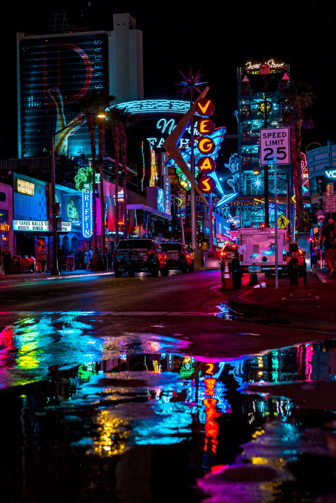 Vibrant Las Vegas Night Cityscape: Neon Lights & Reflective Pavement Wallpaper
