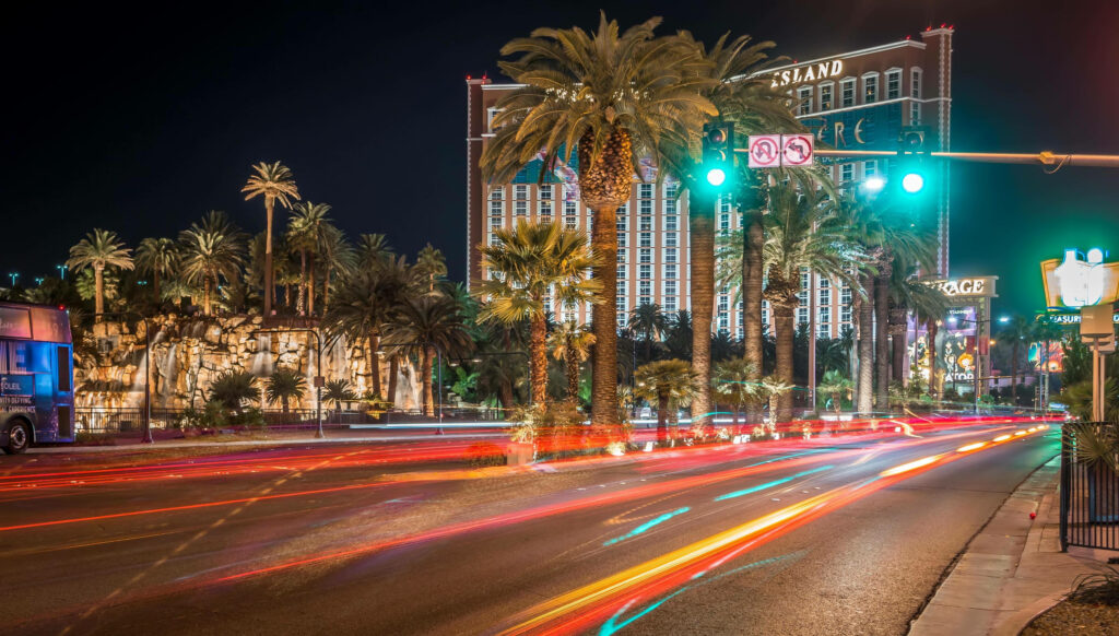 Vibrant Las Vegas Night View: Stoplights, Palm Trees & City Landmarks Wallpaper