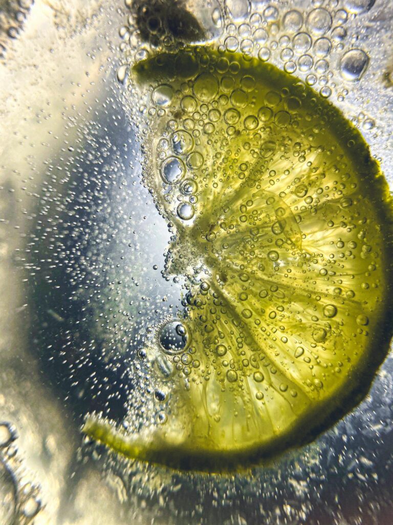 Vibrant Lemon Slice with Bubbles: Refreshing Fizzy Drink Wallpaper
