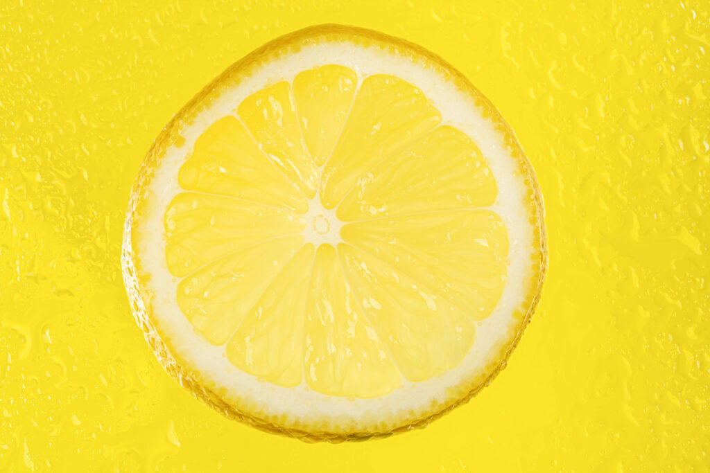 Bright Yellow Lemon Slice Wallpaper: Macro Citrus Texture Background