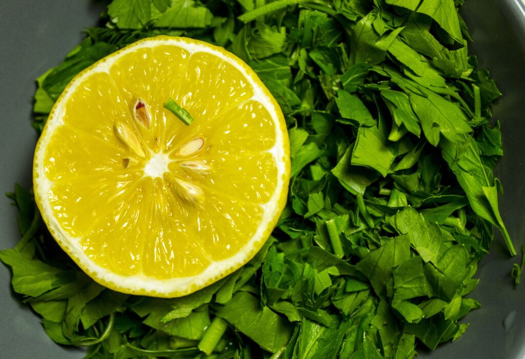 Vibrant Lemon Slice on Parsley - Fresh Herb Wallpaper Background