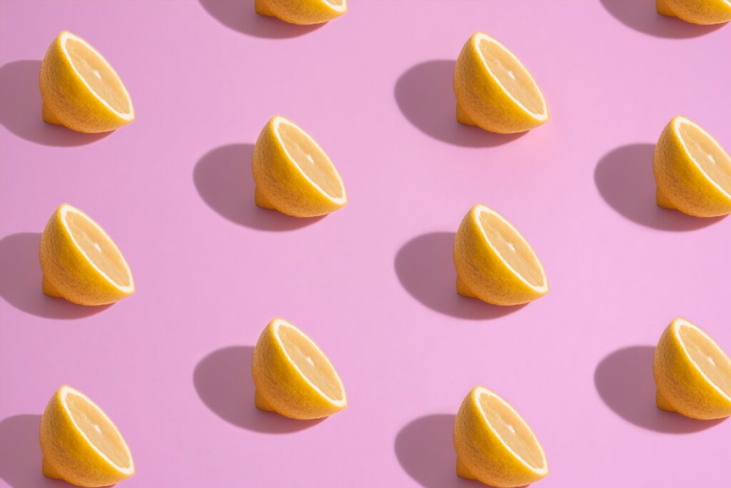 Fresh Lemon Slice Wallpaper on Bright Pink Background - Cheerful Design