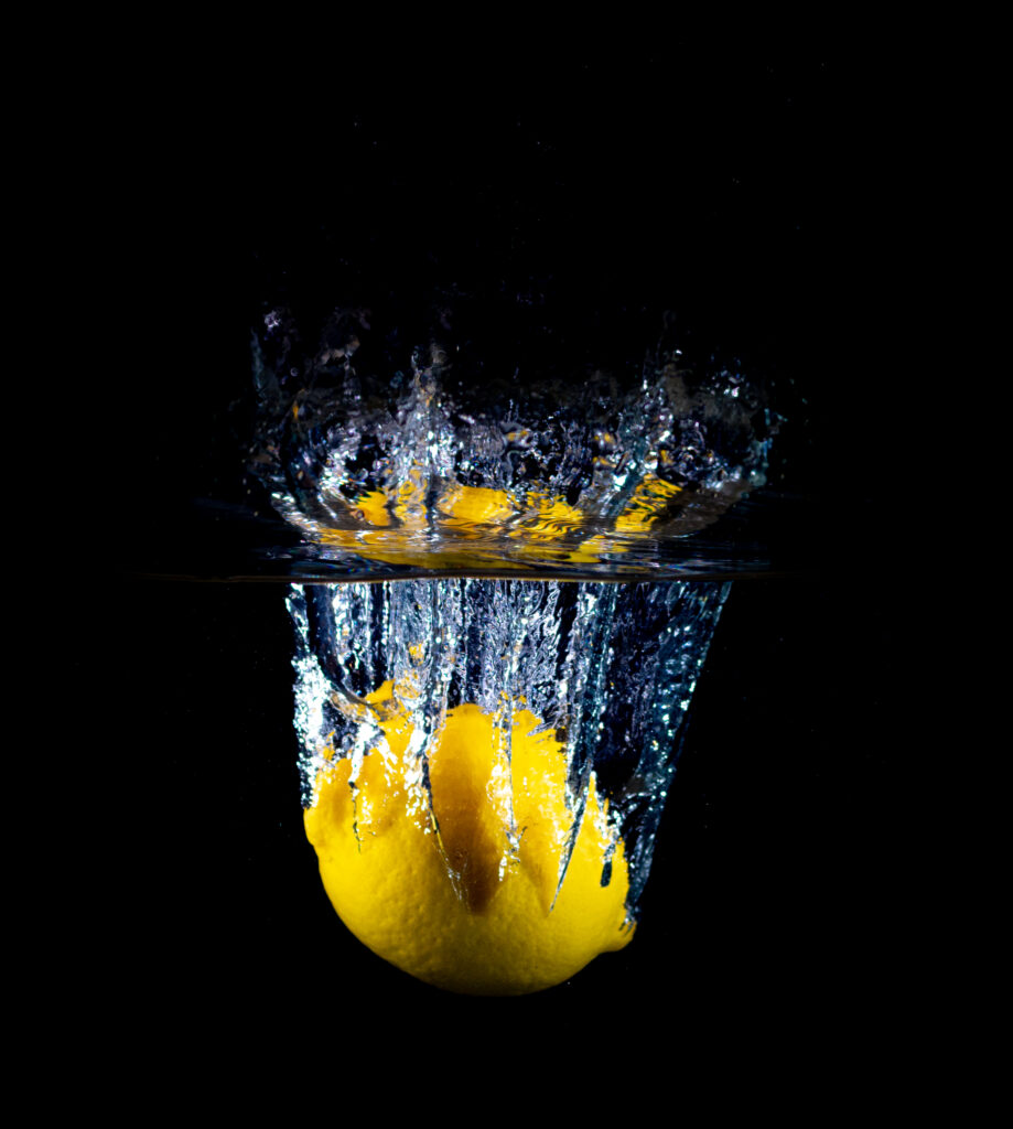 Vibrant Lemon Splash: Dramatic Water Spray Wallpaper Background