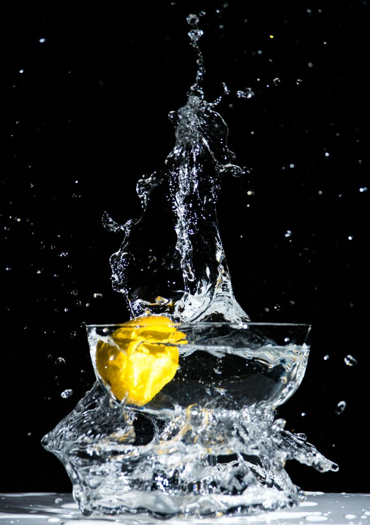 Vibrant Lemon Splash Wallpaper: Refreshing Water Burst Background