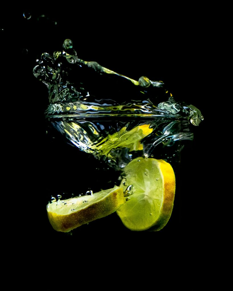 Vibrant Lemon Splash Wallpaper - Fresh Citrus on Black Background