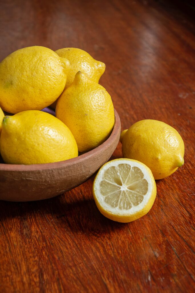 Vibrant Lemon Wallpaper: Rustic Bowl & Wooden Background Beauty