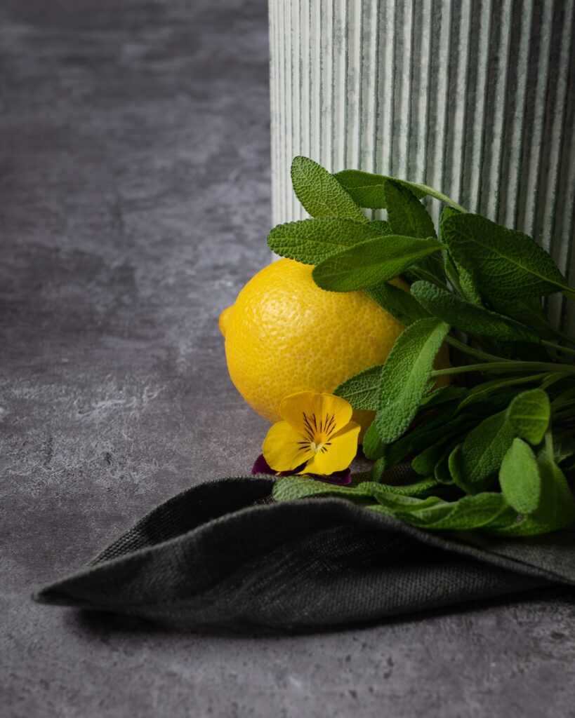 Vibrant Lemon Wallpaper with Green Leaves & Yellow Flower Background