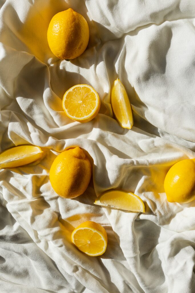 Vibrant Citrus Wallpaper: Yellow Lemons on Crumpled White Fabric