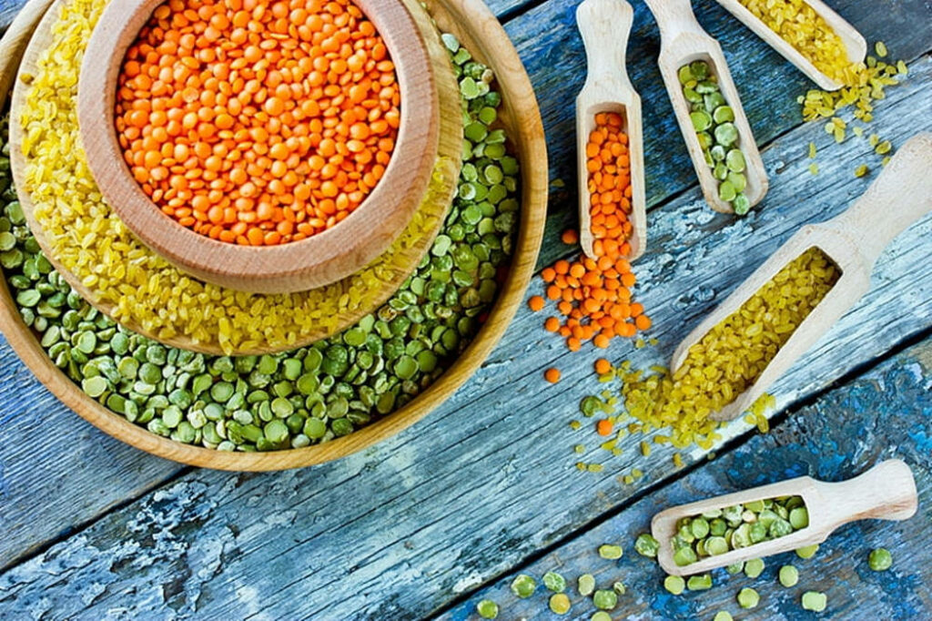 Colorful Lentils in Rustic Bowls: Vibrant Green, Orange, Yellow Display Wallpaper