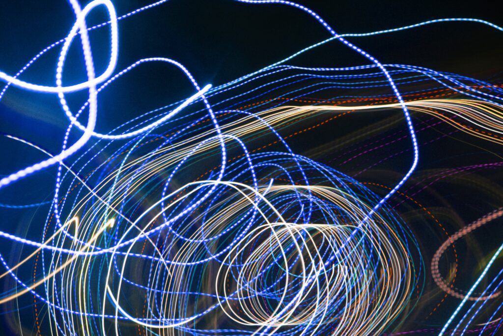Vibrant Light Trails Wallpaper: Dynamic Swirls on Dark Background