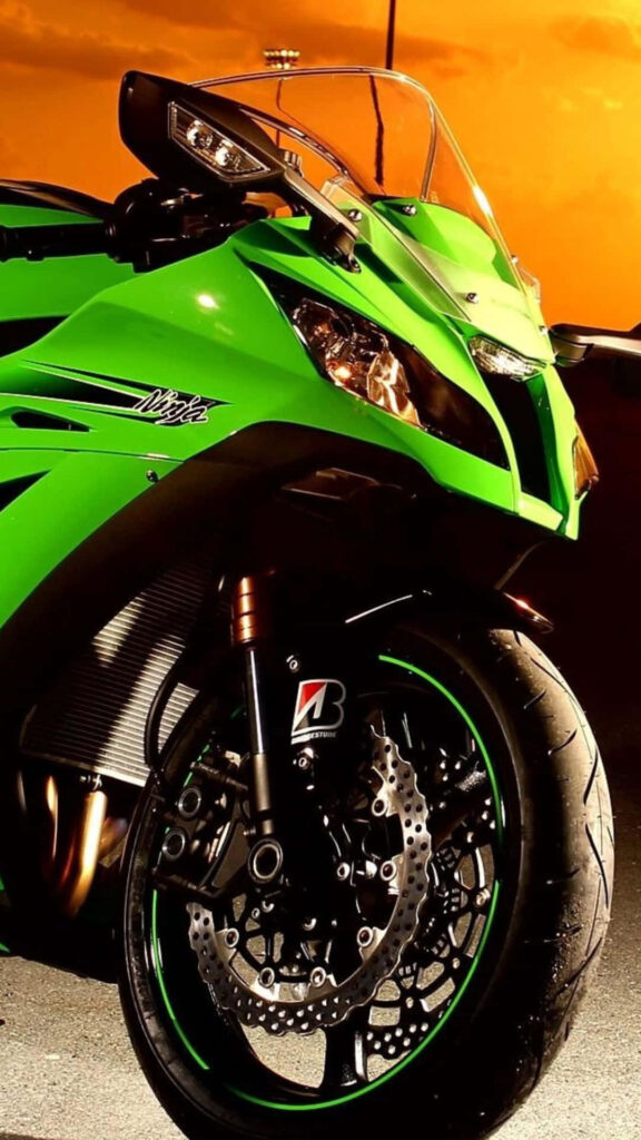 Vibrant Lime Green Motorcycle Wallpaper with Bold Orange Sunset