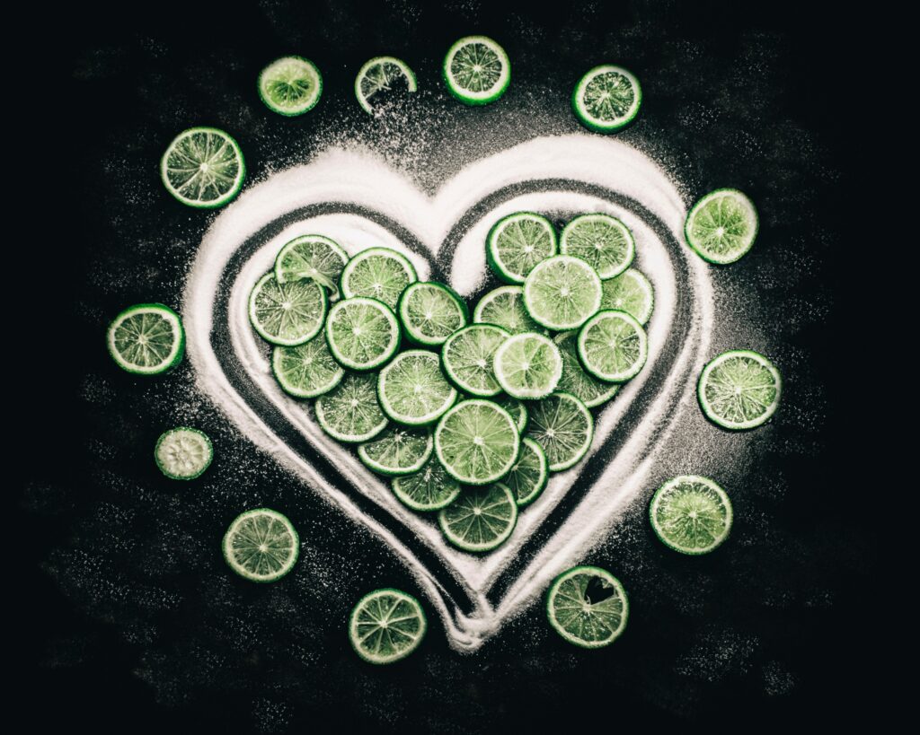 Vibrant Lime Slice Heart Wallpaper on Dark Citrus Textured Background