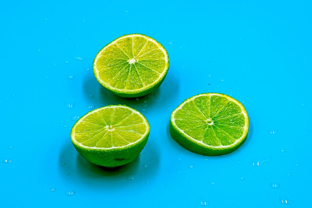 Vibrant Lime Slice Wallpaper: Zesty Citrus Against Blue Background