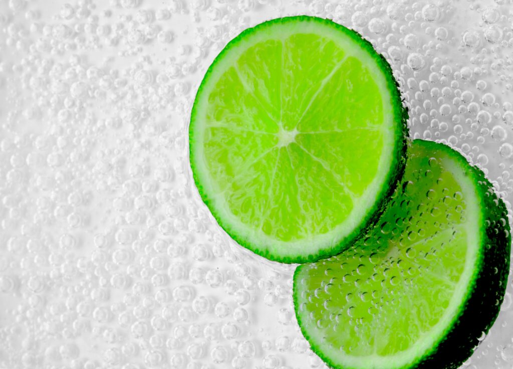 Vibrant Lime Slice Wallpaper: Crisp, Zesty Bubbles Background