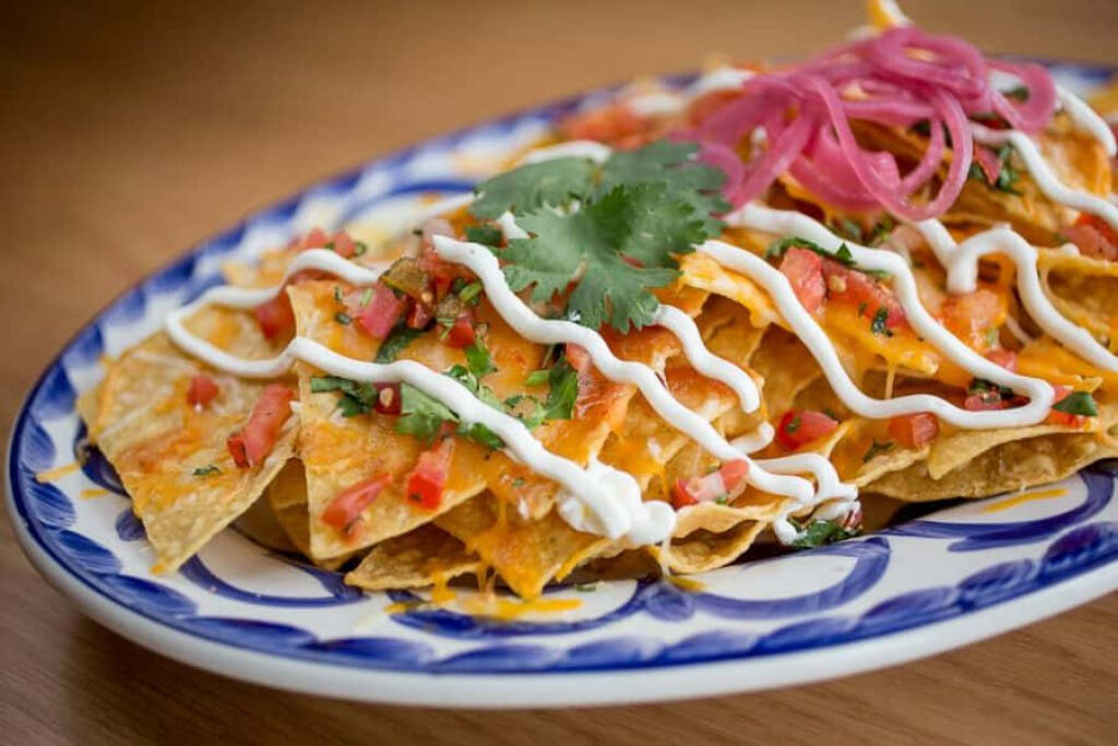 Vibrant Loaded Nachos with Cheese & Pico on a Mexican Wallpaper