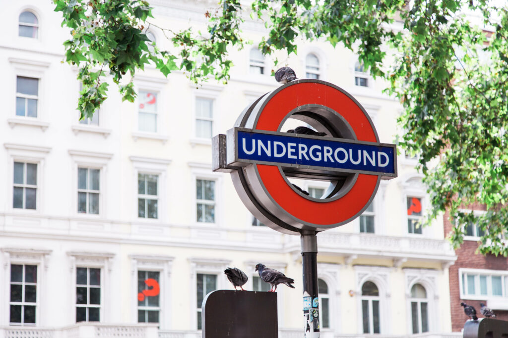 London Underground Sign with Pigeons - Vibrant Wallpaper Background
