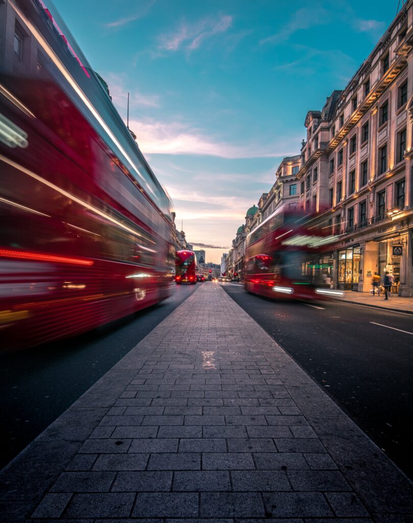 Vibrant London Wallpaper: Red Buses & Historic Architecture at Dusk