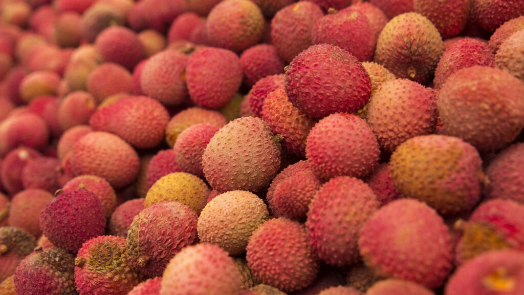 Vibrant Lychee Fruits Wallpaper: Tropical Close-Up Background
