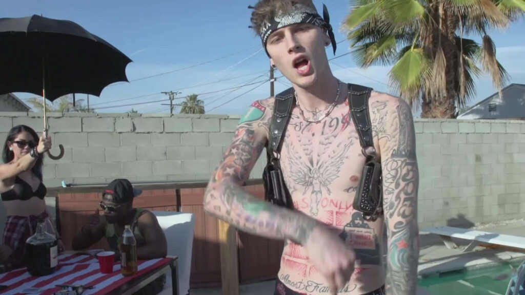 Vibrant MGK Wallpaper: Shirtless with Intricate Tattoos Outdoors