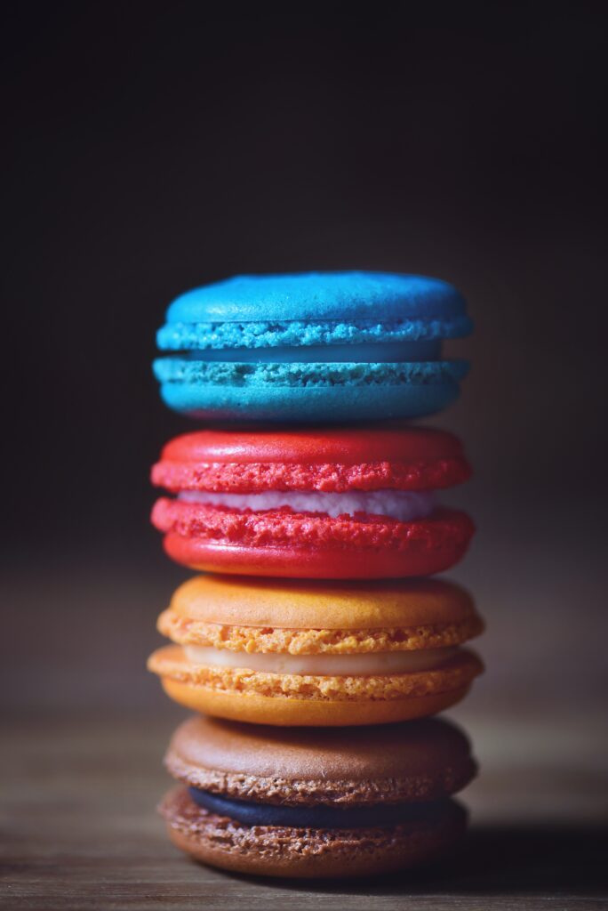 Colorful Macarons Wallpaper: Vibrant Shades of Blue, Red, Orange & Brown
