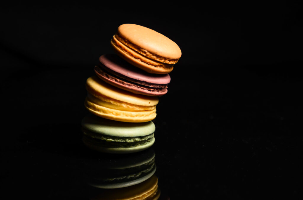 Vibrant Macarons Stack: Colorful Dessert Wallpaper Background
