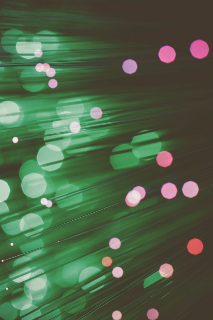Vibrant Macro Optical Fiber Wallpaper with Green Glow & Colorful Bokeh