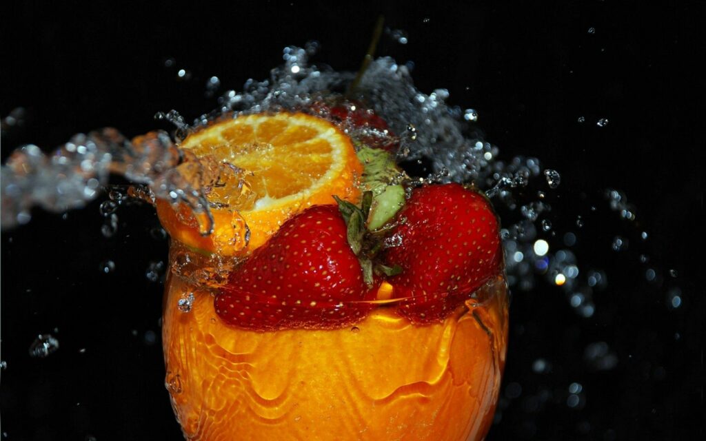 Vibrant Macro Shot: Strawberries & Orange Splash Wallpaper