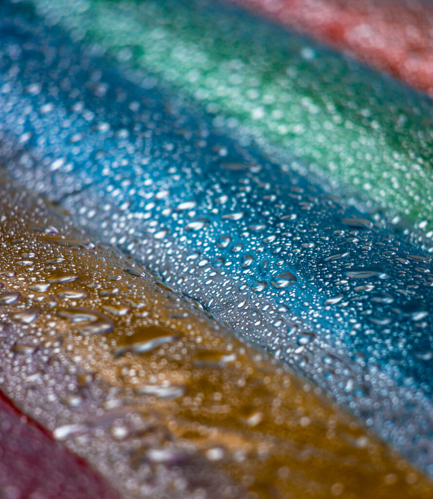 Vibrant Macro Rain Droplets on Colorful Surface - Wallpaper Background