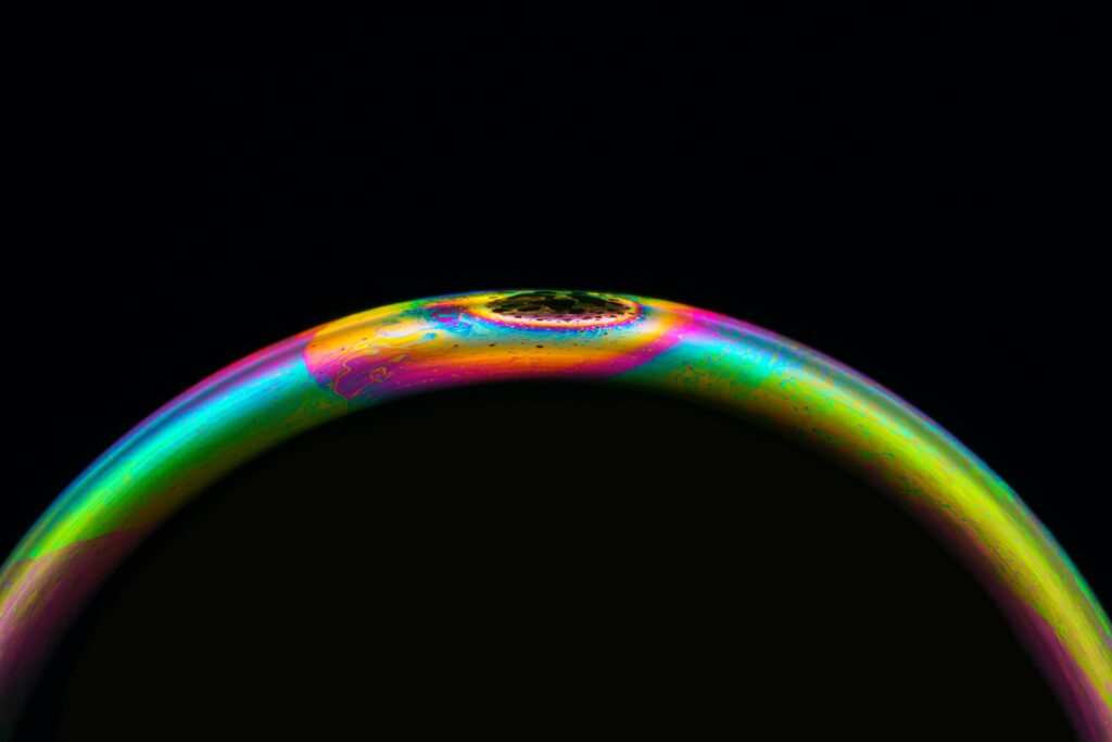 Vibrant Macro Wallpaper: Colorful Soap Bubble on Black Background