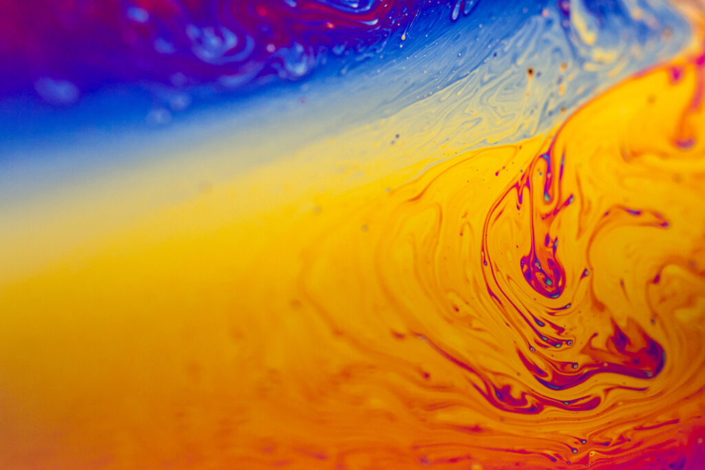 Vibrant Macro Wallpaper: Fluid Patterns in Orange, Yellow & Blue