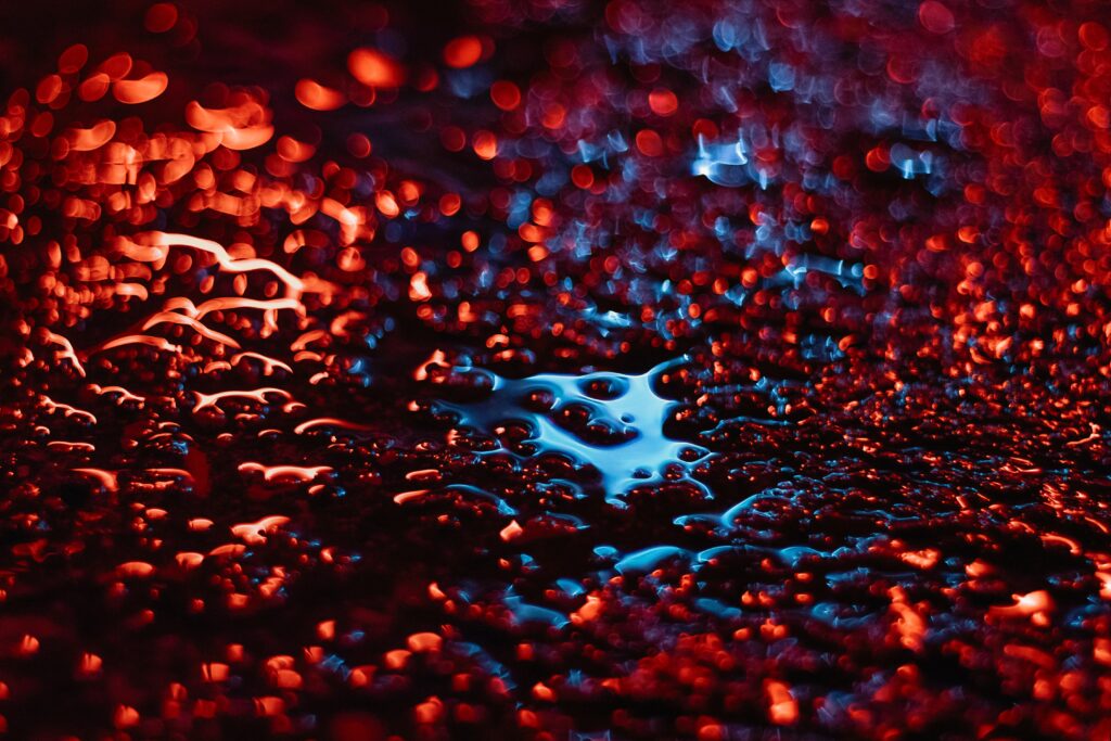 Vibrant Macro Wallpaper: Red & Blue Liquid Droplets with Bokeh Glow
