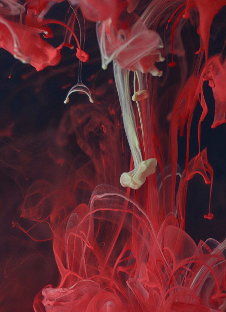 Vibrant Macro Wallpaper: Swirling Red & White Ink Abstract Background