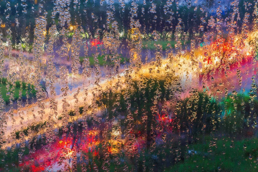 Vibrant Macro Wet Glass Wallpaper with Colorful Lights & Blurred Background