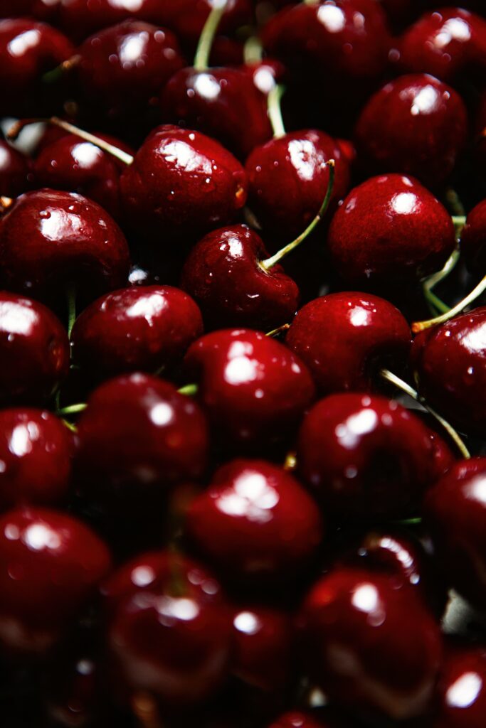 Vibrant Macro Wallpaper: Ripe Red Cherries with Wet Texture Background