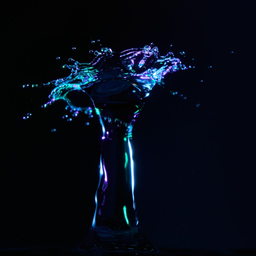 Vibrant Neon Water Splash Macro Wallpaper - Dark Background Art