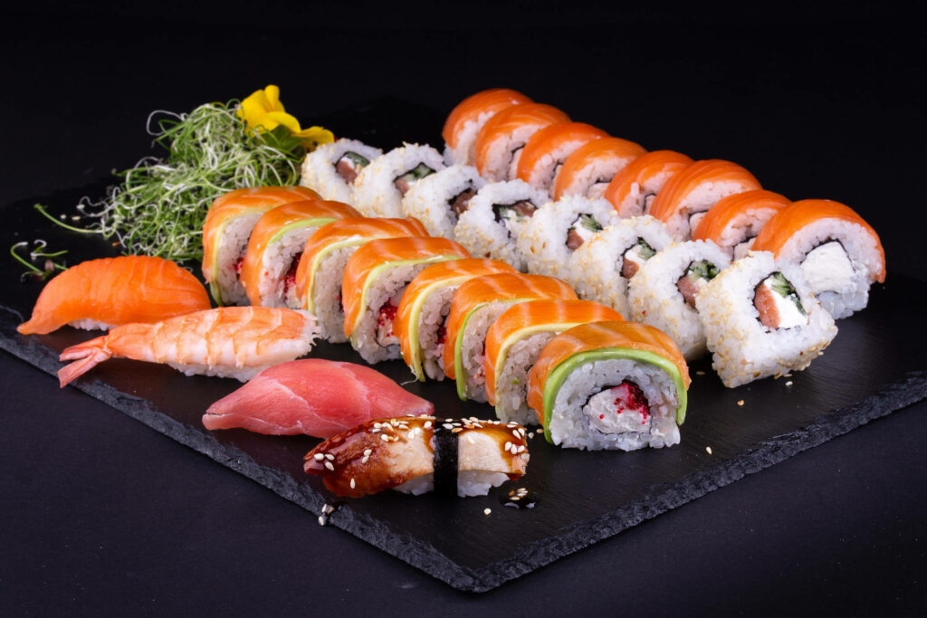Vibrant Maki Roll Platter Wallpaper: Fresh Sashimi on Slate