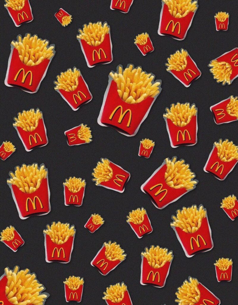 Vibrant wallpaper with repeating McDonald's French fries in red cartons on dark background