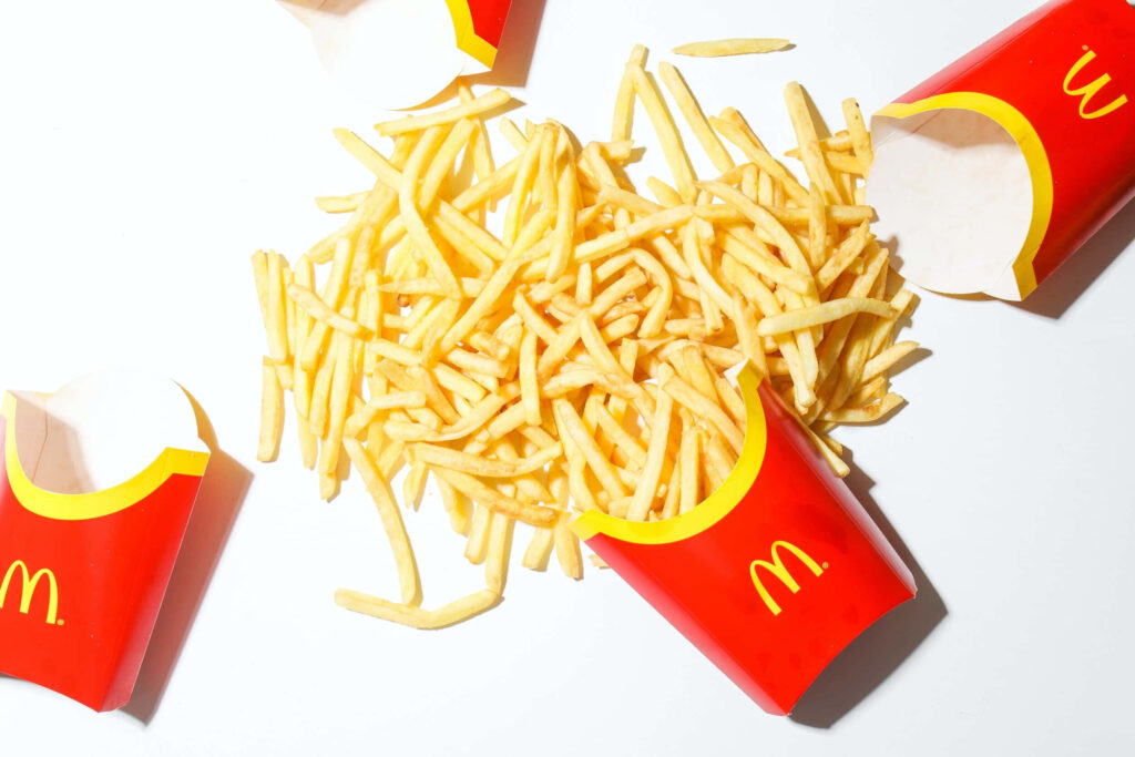 Vibrant McDonald's French Fries Wallpaper: Spilled Red & Yellow Scene