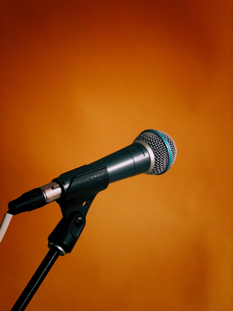 Vibrant Microphone Wallpaper: Bold Orange Background for Creatives