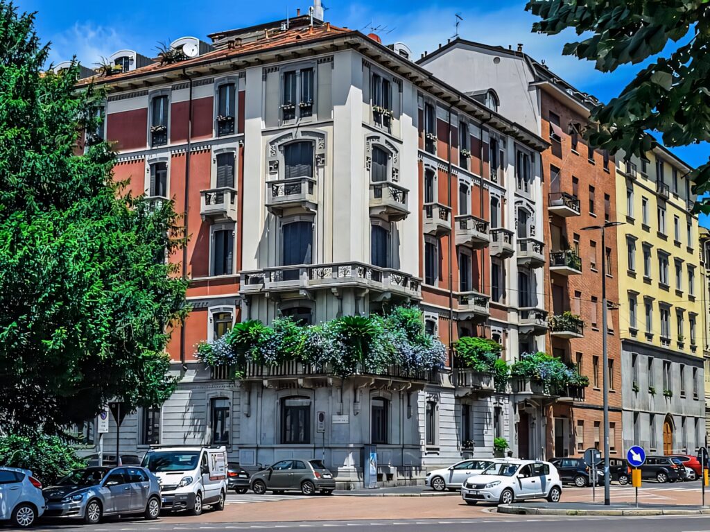 Vibrant Milan Buildings: Classic Architecture & Lush Greenery Wallpaper