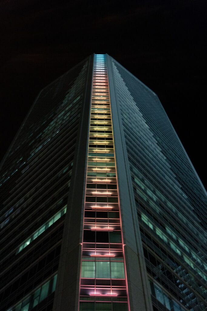 Vibrant Nighttime Wallpaper of a Modern Illuminated Building Facade